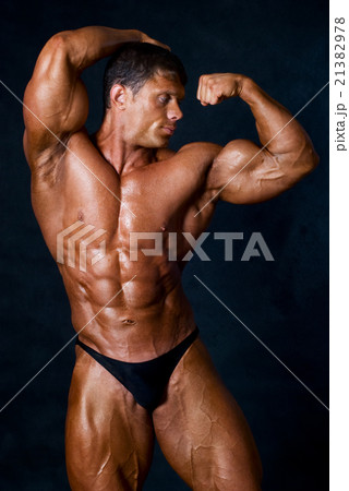 Young athletic man showing his muscles Young athletic man showing his muscles 21382978