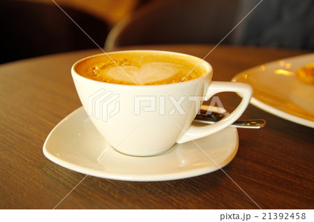 cappuccino hot coffee in white cup on wood table 21392458