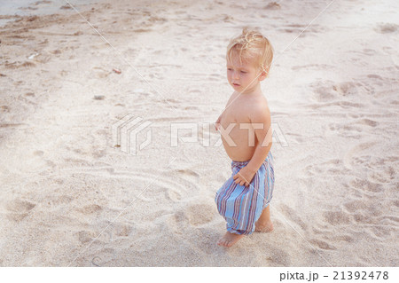 Toddler walking on a beach 21392478
