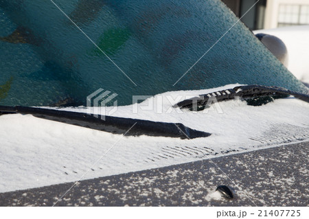 Ice and snow cover windshield and car hood Ice and snow cover windshield and car hood 21407725