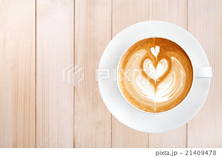 Top view latte art coffee on wood background Top view latte art coffee on wood background 21409478