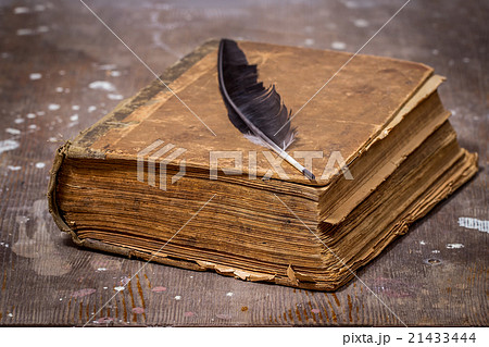 Ancient book in a grunge style on a wooden table 21433444