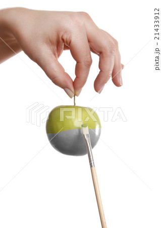 Female hand painting a green apple Female hand painting a green apple 21433912