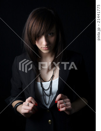 beautiful serious girl on dark background 21441775