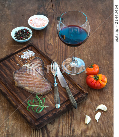 Cooked meat t-bone steak on serving board with Cooked meat t-bone steak on serving board with 21443464