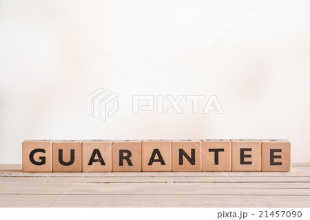 Guarantee sign on a wooden desk 21457090