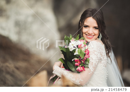 Beautiful bride posing near rocks with beautiful Beautiful bride posing near rocks with beautiful 21458479
