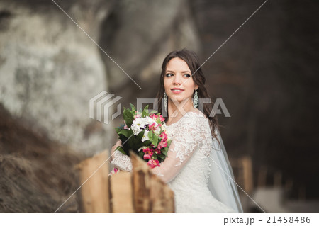 Beautiful bride posing near rocks with beautiful Beautiful bride posing near rocks with beautiful 21458486
