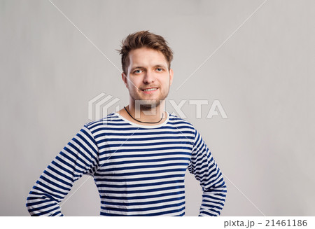 Hipster man in striped t-shirt, gray background 21461186