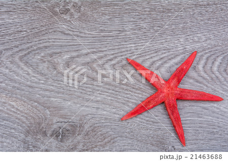 Red starfish on a wooden background Red starfish on a wooden background 21463688