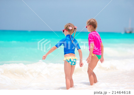 Adorable little girls at beach having fun in 21464618