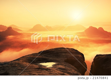 Warm misty autumn land in red colorful vapor. Rock Warm misty autumn land in red colorful vapor. Rock 21470841