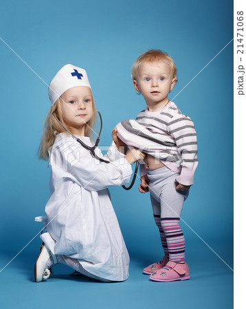 two cute little girls playing doctor 21471068