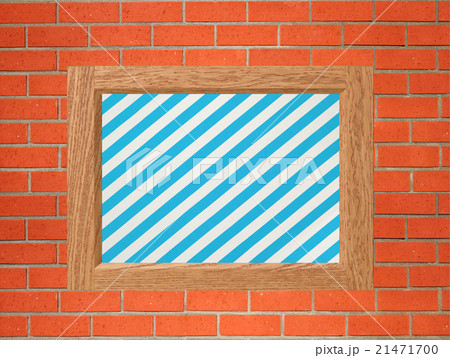 Old frame with striped canvas on orange brick wall 21471700
