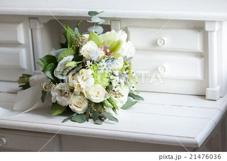 Wedding bouquet with white roses on wooden surface 21476036