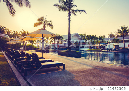 Beautiful Silhouette palm tree with umbrella and chair Beautiful Silhouette palm tree with umbrella and chair 21482306