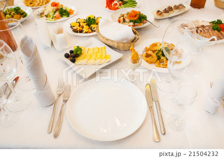 Table served with different food and flatware Table served with different food and flatware 21504232