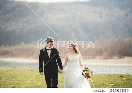 Beautiful wedding couple, bride, groom posing and Beautiful wedding couple, bride, groom posing and 21505859