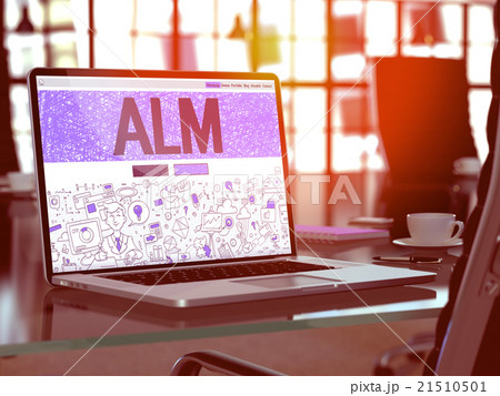 ALM on Laptop in Modern Workplace Background. 21510501