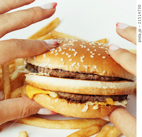 woman hands with manicure holding hamburger and 21514730