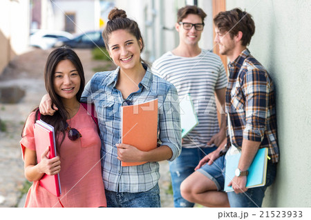 Hip friends holding notebooks Hip friends holding notebooks 21523933