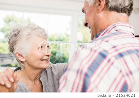 Smiling senior couple dancing Smiling senior couple dancing 21524021