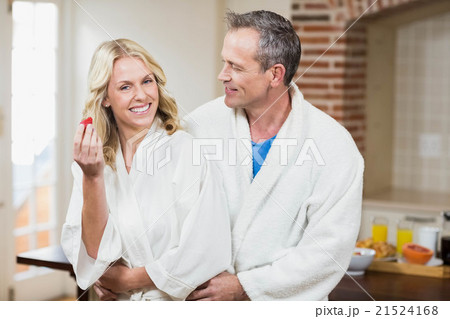 Cute couple cuddling in bathrobes Cute couple cuddling in bathrobes 21524168