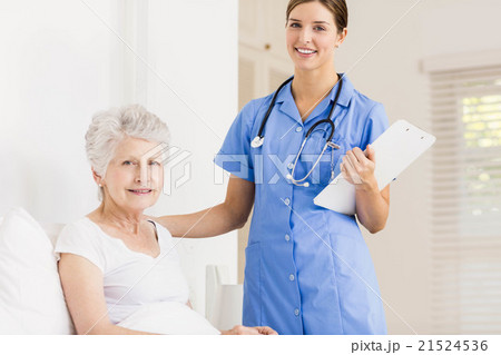 Doctor taking care of suffering senior patient Doctor taking care of suffering senior patient 21524536