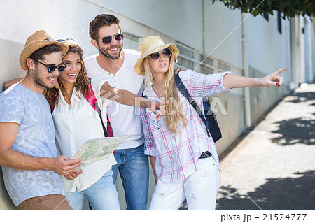 Hip friends holding map and pointing 21524777