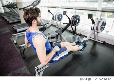 Handsome man doing exercise on drawing machine 21524842