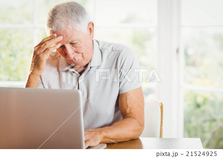 Worried senior man using laptop Worried senior man using laptop 21524925