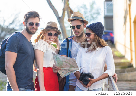 Hip friends reading map and taking photos 21525029