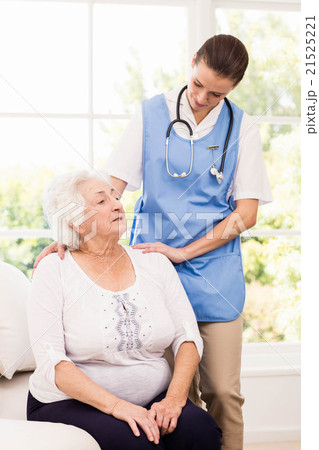 Nurse taking care of sick elderly woman 21525221