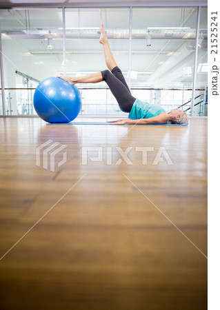 Fit blonde on mat exercising with fitness ball 21525241