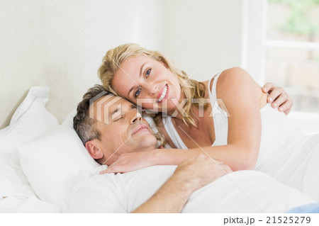 Cute couple cuddling in bed 21525279