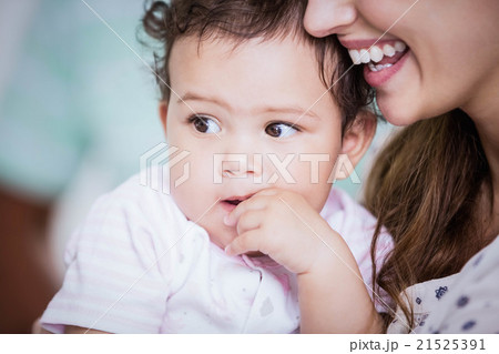 Beautiful baby held by her mother 21525391