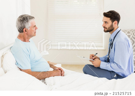 Handsome nurse visiting a mature man 21525715