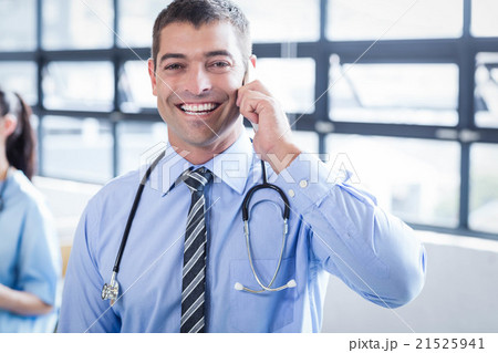 Happy doctor on the phone 21525941