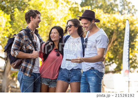 Hip friends looking at smartphone Hip friends looking at smartphone 21526192