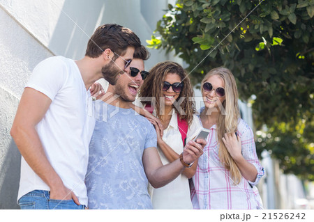 Hip friends looking at smartphone Hip friends looking at smartphone 21526242