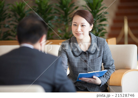 ロビーでお客様応対をするフロントの女性 21528746