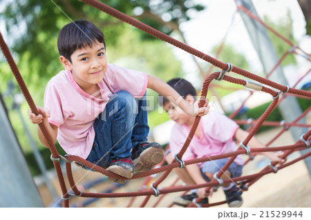 Little asian boy climbing rope obstacle activity Little asian boy climbing rope obstacle activity 21529944