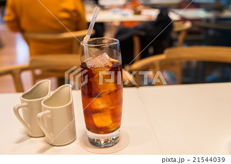 Ice tea in glass with cup of cream and syrup 21544039