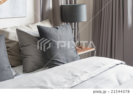 grey pillow on white bed in modern bedroom grey pillow on white bed in modern bedroom 21544378