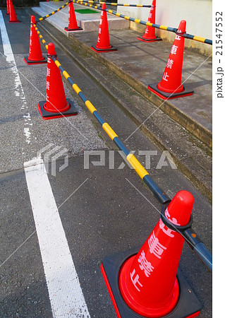 赤い三角コーンとコーンバーによる駐車禁止表示の写真素材