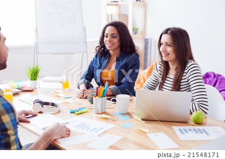 Cheerful friendly team is discussing new project Cheerful friendly team is discussing new project 21548171