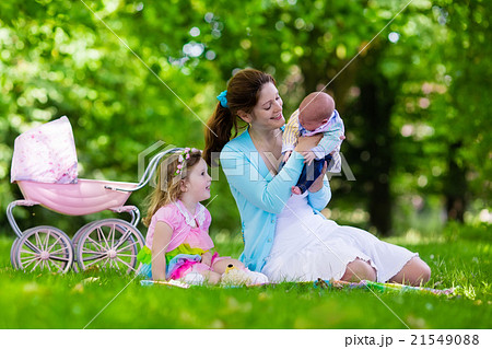 Mother and kids enjoying picnic outdoors Mother and kids enjoying picnic outdoors 21549088