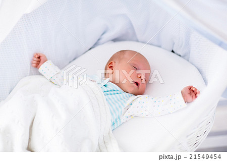 Cute newborn baby in white bed 21549454