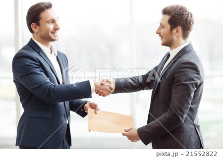 Positive business partners shaking hands 21552822