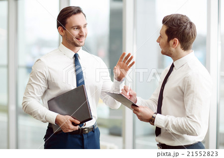 Pleasant business partners talking with each other Pleasant business partners talking with each other 21552823